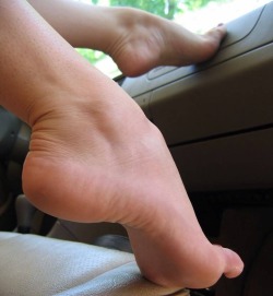 This photo of Chloe J. with her small high arched feet on the dash belongs to Foot Factory. There is an accompanying video on http://www.footfactory.com as well. I don&rsquo;t know why people take off my WATERMARK!