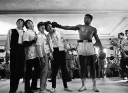 prominentmen:   “The Beatles, in Miami Beach to perform on the Ed Sullivan Show on their first tour of the United States, were taken to the training camp of boxer Cassius Clay, later known as Muhammad Ali. Clay was preparing for his February fight against