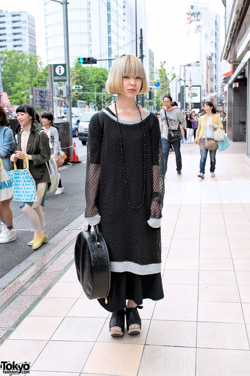 Harajuku designer wearing a resale oversized net top with a handmade maxi-skirt, Trippen rocking hor