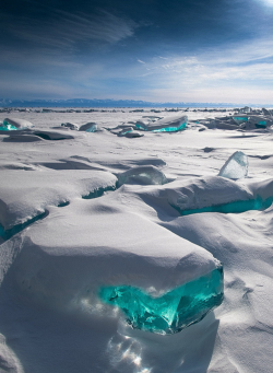 autoentropy:  In March, due to a natural phenomenon, temperature, wind and sun cause the ice crust to crack and form beautiful turquoise blocks or ice hummocks on the surface of Lake Baikal in Siberia. 