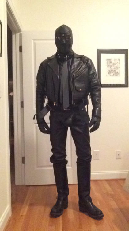 leatherslaveobject: In my new uniform when I’m at home now. Encased in thick black leather from head