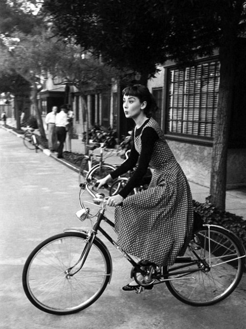 alwaysbevintage:Audrey Hepburn riding a bike during the filming of “Sabrina”, photographed by Mark S