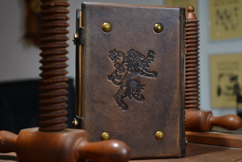 Medieval styled leather journal with heraldic lion on the front and back cover…