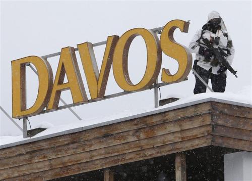 gunrunnerhell:  Davos A Swiss special policeman patrols on a roof before the start of the annual meeting of the World Economic Forum (WEF) 2014 in Davos January 21, 2014. (REUTERS/Ruben Sprich)
