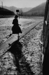 undr:Robert W. Kelley. Girl walking in muddy yard. John’s Creek school, Pike County. 1955