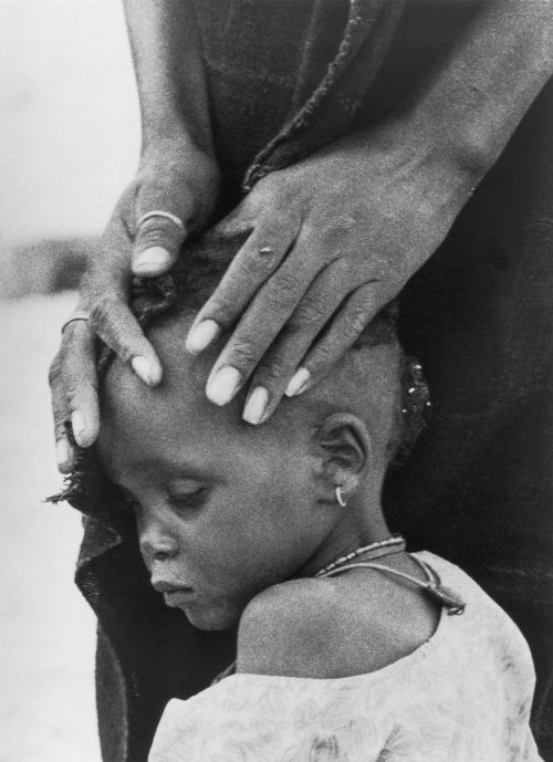 The Faces of Hunger. A mother comforts her child, both victims of drought. Year: 1974 Photographer: 