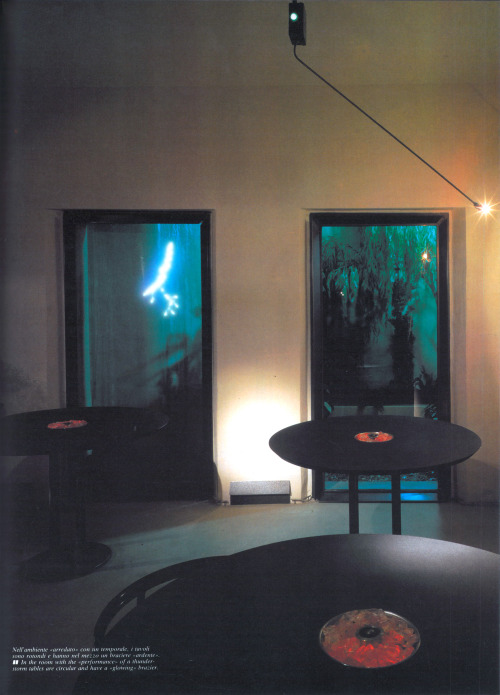 80sretroelectro:  Club, with neon thunderstorm outside and round tables. 1986.  Scan  
