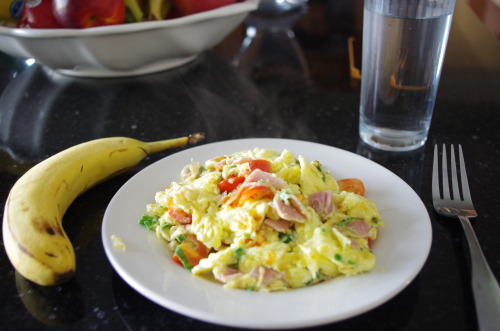 breakfast eggs with ham, tomato, and green onion and also a banana i love my eggs.  i’m going 