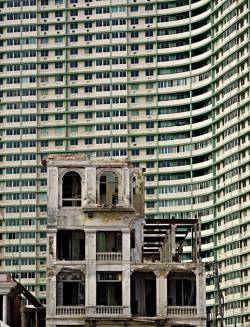 architectureofdoom:  architizer:  Richard Sexton’s ravishing take on Latin Caribbean architecture.  Partially demolished building with Edifico FOSCA in the background, Vedado neighborhood, Havana, Cuba