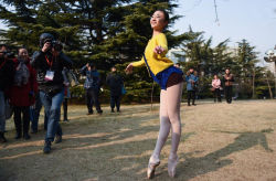 heypantyhose:  In Beijing, China, before the  examination of art, a girl danced outside the examination place in white tights. 