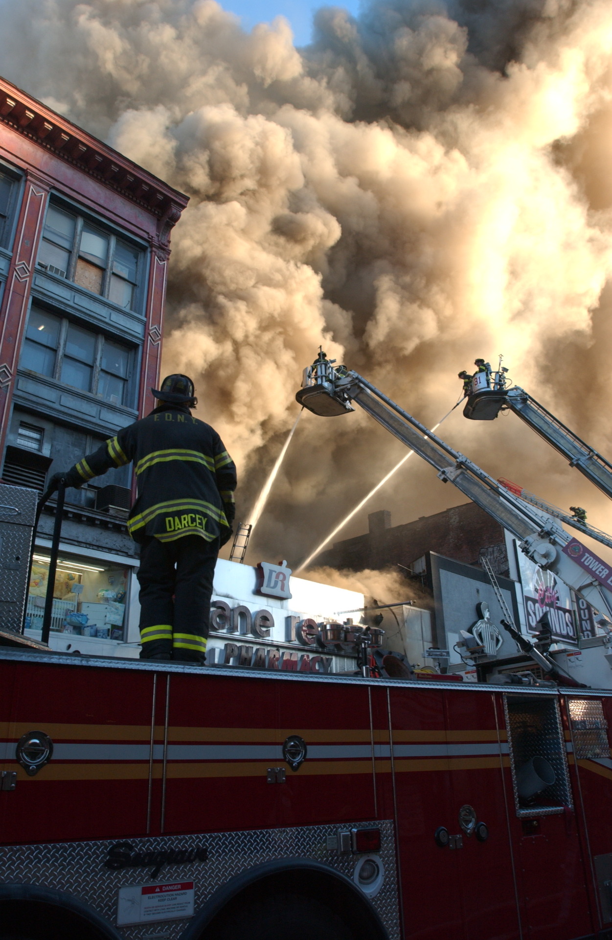 FDNY members battle a 4-alarm fire in the Bronx, September 2002.