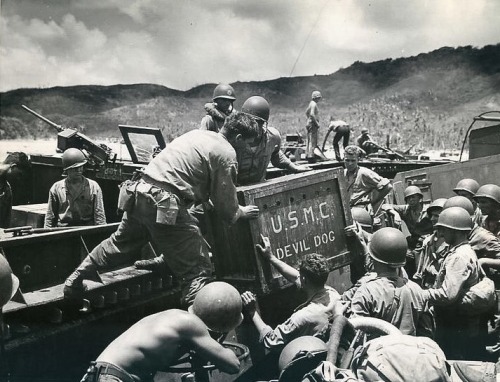 A boxed Devil Dog: Off the shores of Guam, Coast Guardsmen and Marines handle a “Devil Dog” with car