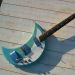 thepit:bleachedvi0let:Crucianelli Spazial 1965 Crecent Moon guitar 🌙[ID:4 pictures of an electric guitar taken from various angles. Its body is in the shape of a crescent. It’s light blue with a white pickguard. It has a vibrator arm/End ID]