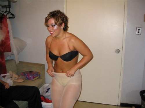 Candid in a changing room  of a woman in white pantyhose and little bra. Woman in pantyhose