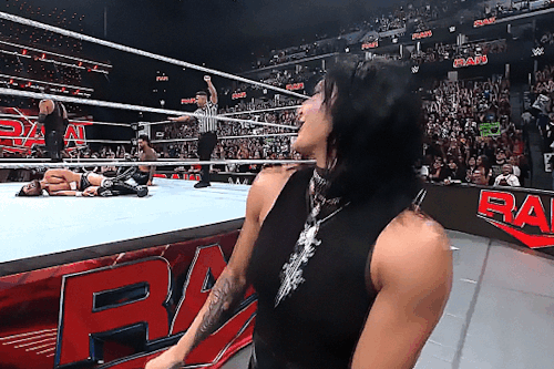 A gif of Rhea Ripley. She is singing along to Jey Uso's theme music. She is seen here singing "day one."