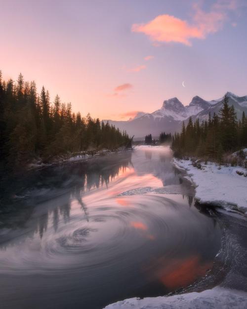 adventuresinfinity:  It was a chilly morning, chunks of ice were flowing down the river and some of them got caught up in this vortex so I decided to make a long exposure to show the movement of the water. Canmore, Alberta. [OC] [1080x1350] | Source: