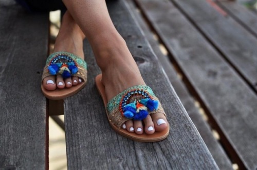 Unique banded sandals on pretty feet.