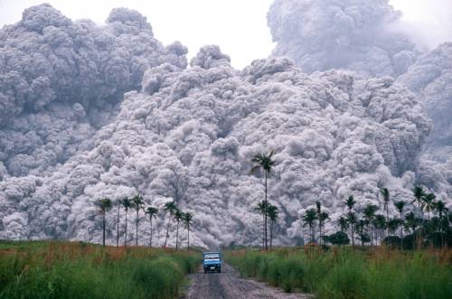 A pickup truck flees from the pyroclastic flows spewing from the Mt.Pinatubo volcano in the Philippines, on June 17, 1991. This was the second largest volcanic eruption of the 20th century -