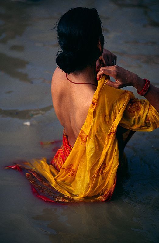 wasbella102:  A female pilgrim bathing in the Ganges river in India.  by Dariusz