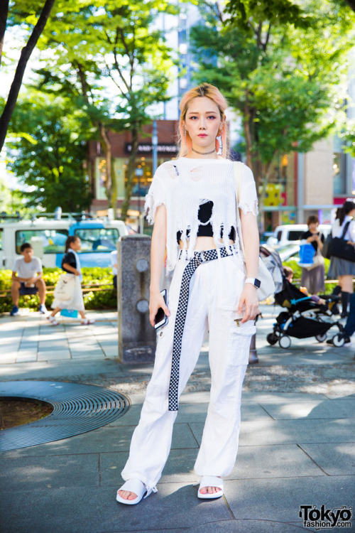 Miho on the street in Harajuku wearing a monochrome resale street style with a destroyed sweater and
