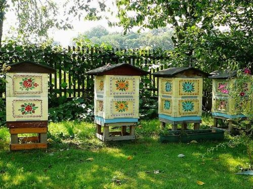 nighttyger:gazophylacium:Decoratively painted beehives, Zalipie, Poland.[Image description - four be