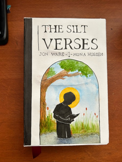 ID: The front cover. It has a white background, and black text reads "The Silt Verses", and beneath it: "Jon Ware - 1 - Muna Hussen". Below the text is an arch which contains a silhouette of Faulkner, who is standing knee deep in water and holding an open book. There are cattails and a tree behind him, and a halo framing his head. /end ID