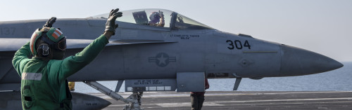 Armed and Ready…. PERSIAN GULF (October 29, 2020) – A flight deck crew member signals while an