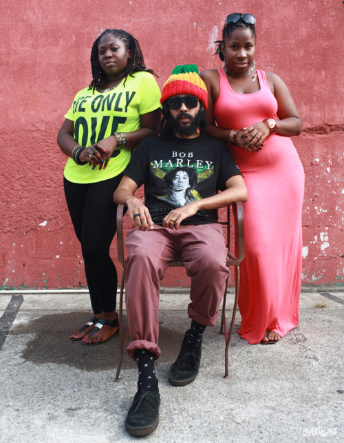 Rising reggae star Protoje sits for a portrait with two of the singers in his band. Photo by Alexander Richter.