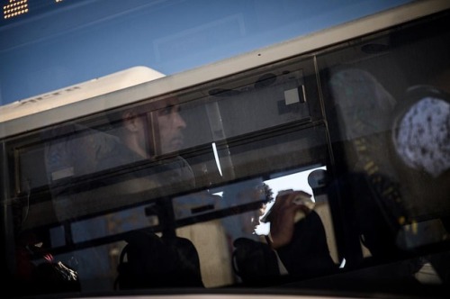 African asylum seekers board a bus after being released from Saharonim Prison in the Negev desert.