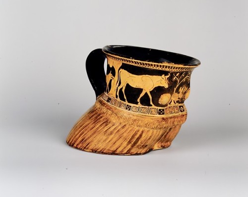 ancientpeoples:Terracotta cup in shape of a cow’s hoof It shows a cow, dogs or wolves, a 