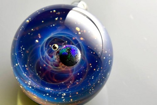 zombies-with-radios:  http://plusalpha-glass.com/index.html  Artist Satoshi Tomizu creates small glass spheres that appear to be miniature solar systems or galaxies, in which planets made of opal are circling into spirals of colored glass and gold flakes.