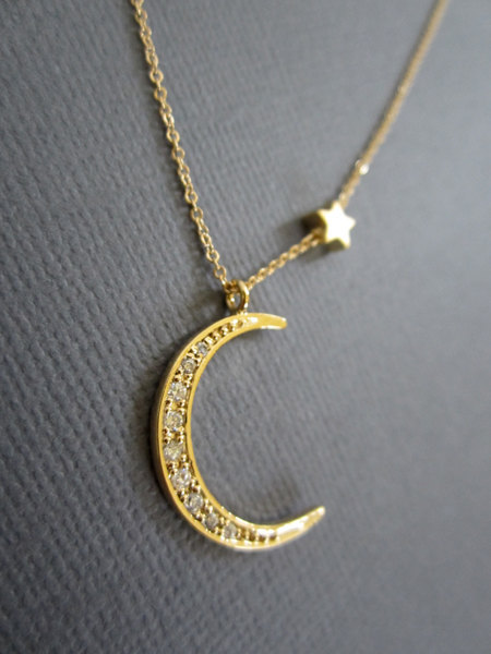 wickedclothes:  Crescent Moon Necklace Simple yet elegant, this crescent moon pendant is gold-plated and is embedded with CZ crystals. Accompanied by a tiny star charm. Hung on a gold-filled chain available in various lengths. Sold on Etsy.
