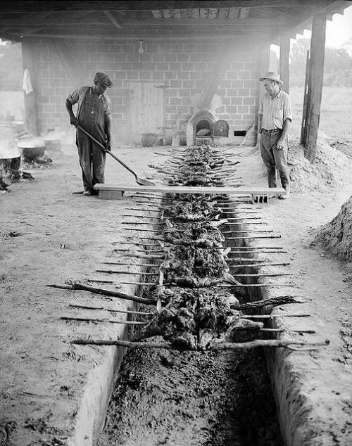 Barbecuing pork over an open pit, Braswell Plantation near Rocky Mount, NC, September 1944.