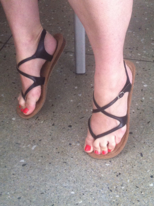 sandalsandspankings:Strappy thong sandals on display.