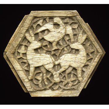 This small hexagonal (six-sided) plaque has two levels of carved decoration. The shallow carved inte