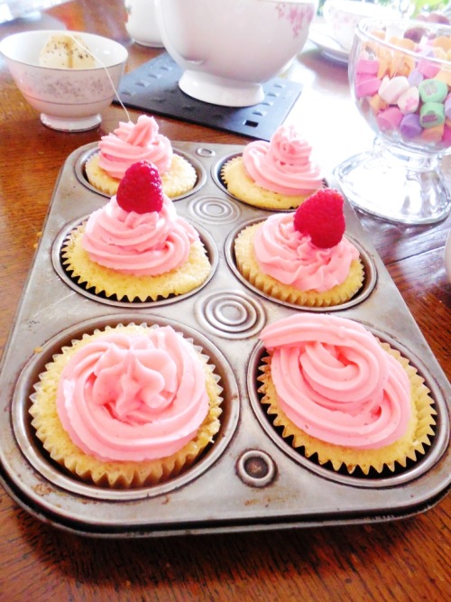 Vanilla rose cupcakes with raspberry-vanilla buttercream, back tea, and sweethearts. 