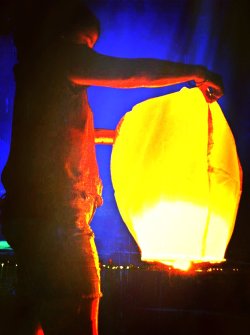 Flying Chinese lanterns off the bay with