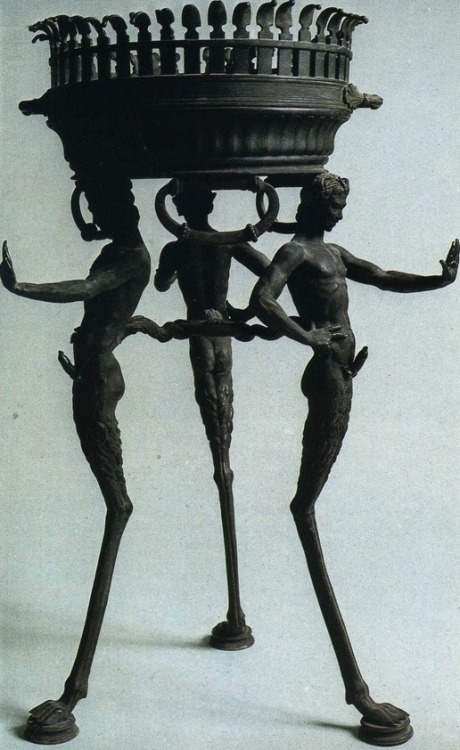 Three slender ithyphallic fauns supporting a basin, found in a house in Pompeii.