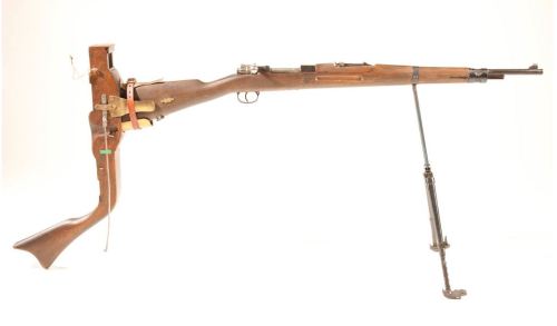A bolt action periscope trench rifle, I believe its a Czech VZ-24.  Not World War I but possibly Wor