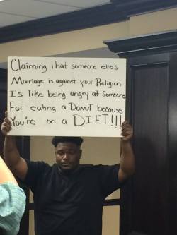 stunningpicture:This guy was protesting at Mobile County Probate Court in Alabama. I want to give him a donut.