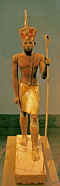 egypt-museum:  Wooden Statue of King Senusret I  This figure wears the ‘Deshret’ or red crown of Lower Egypt and the face appears to reflect the features of the reigning king, most probably Senusret I. However, the divine kilt suggests that the statuette