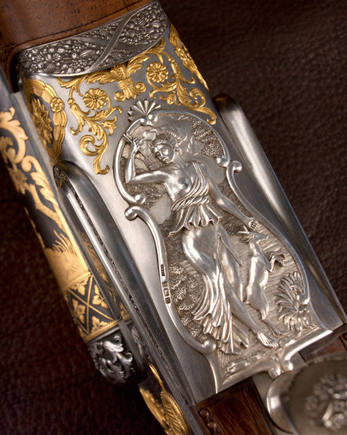 A very ornate 12 gauge double barrel shotgun decorated in the style of 19th century gunmaker Nicolas