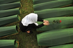 Politics-War:a Bosnian Muslim Woman Mourns Over The Casket Of A Relative, One Of