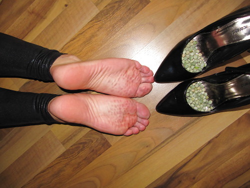(via Foot torture with peas in high heels, leggings and corset)