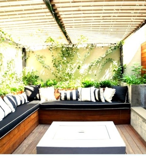 Pergolas - Modern Deck Example Of A Ground-level Deck With A Fire Pit And A Pergola In A Medium-sized