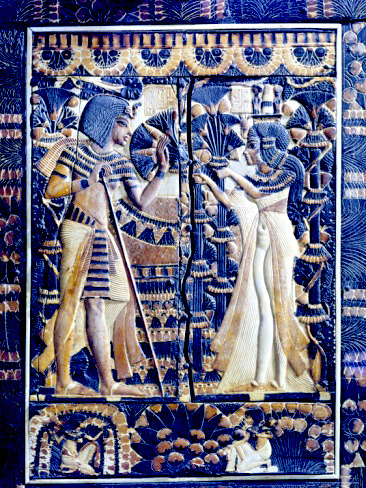 Boy Pharaoh Tutankhamun in a garden with his bride Ankhesenamun. Ivory plaque from a lid of a coffer