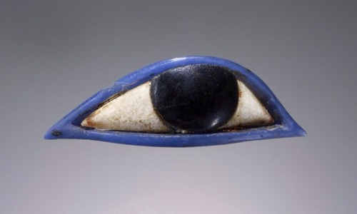 grandegyptianmuseum:Egyptian Glass Inlay in the Form of an Eye (glass and gypsum, 1.4 x 4.6 cms). In