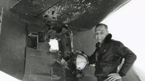 peashooter85:No stranger to danger was he…John Glenn posing with the damaged tail of his fighter jet