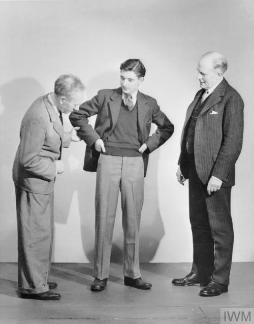 Men trying on utility clothes with austerity regulations during WW2.In 1942 and 1943, the Board of T