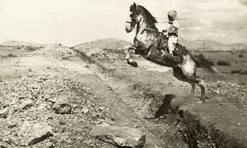 A young North American girl jumps her horse over a ditch in Mexico, May 1914.Photograph by Shirley C